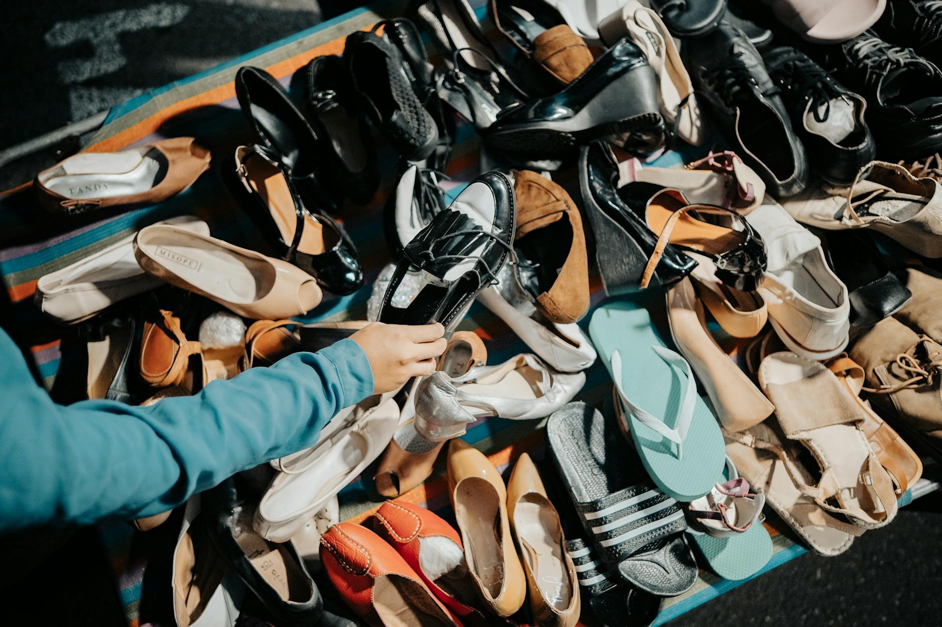 Variety of footwear on display at a market stall — affordable on-trend sandals